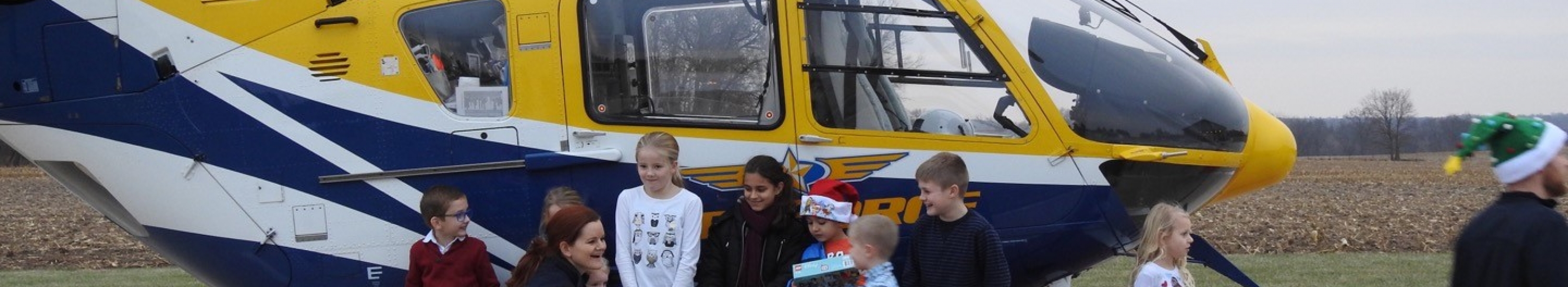 children in front of medforce aircraft