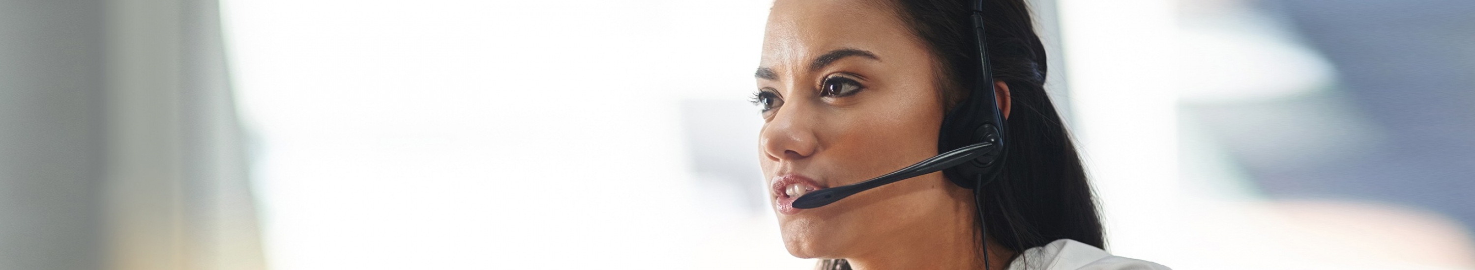 woman with a phone headset on answering a call