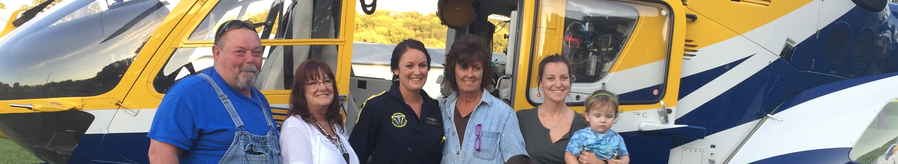 medforce crew member and happy family in front of medforce aircraft
